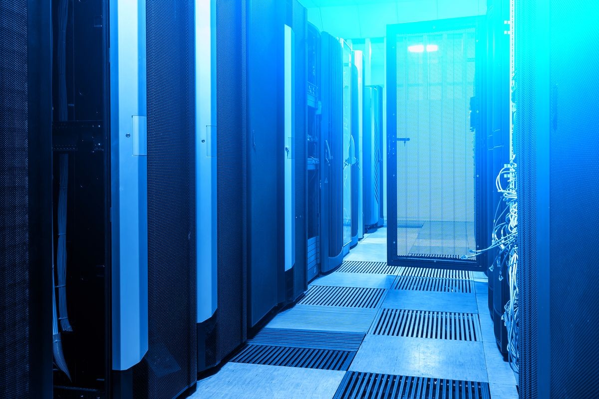 Modern web network and internet telecommunication technology, big data storage and cloud computing computer service business concept:. Server room interior in datacenter in blue light